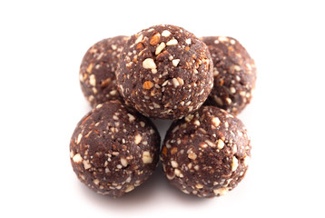 Chocolate Energy Protien Balls Made of Raw Organic Nuts and Dates on a White Background
