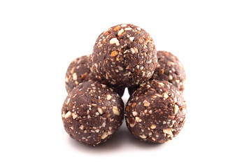 Chocolate Energy Protien Balls Made of Raw Organic Nuts and Dates on a White Background