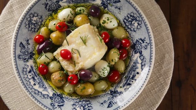 Slide shot codfish on the plate with smoke. Top View.