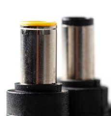 Plugs for charging a laptop on a white background