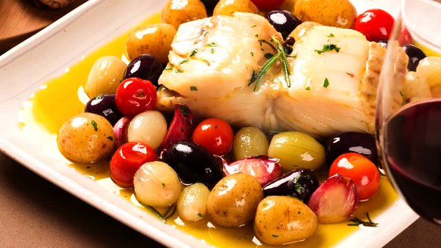 Slide shot codfish on the plate with smoke. Top View.