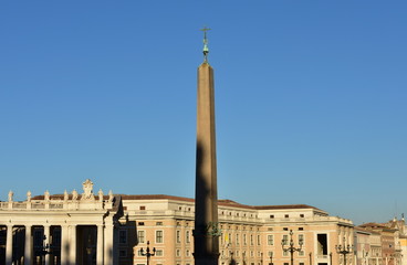 View of St. Peter’s Square with the egyptian Obelisk and blue sky at sunset. Vatican City, Rome, Italy.