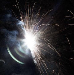 sparks from metal welding at a construction site