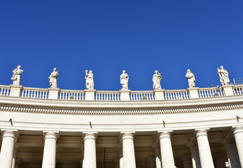 Bernini&rsquo;s Colonnade and statues at St. Peter&rsquo;s Square with blue sky. Vatican City, Rome, Italy.
