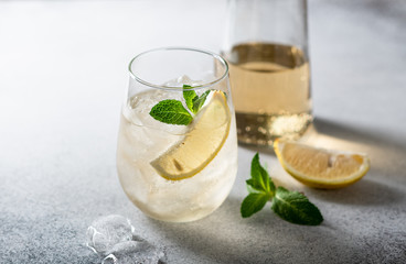 Cold drink. Lemonade with lemon, mint and melted ice . Horizontal orientation