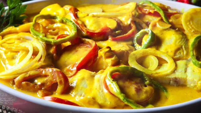 Slide shot Brazilian moqueca on the table with smoke. Top View