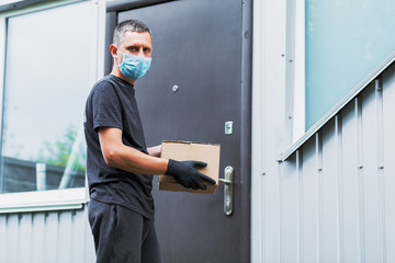 Home delivery shopping box man wearing gloves and protective mask delivering packages at door.