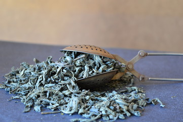 green herbal tea  in a clamping spoon for tea 
