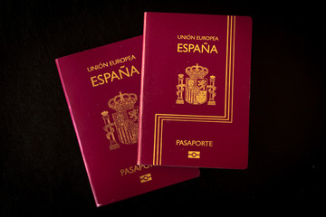 Buenos Aires, year 2020: Spain passport of the European Union. Travel documents. Espa&ntilde;a country, spanish language. Black background.