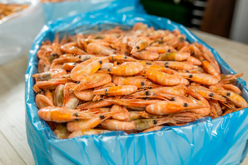 many shrimp of different sizes in a box