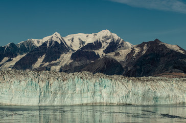 Alaska Cruise to Glacier Bay national park, breathtaking close-up view on the Johns Hopkins Glacier from cruise ship, snow capped mountains, clear blue sky. Gulf of Alaska.