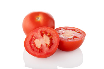 Sliced tomatoes. Two half one whole tomato on white background.
