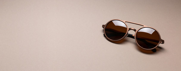 Brown classy sunglasses on minimal paper background
