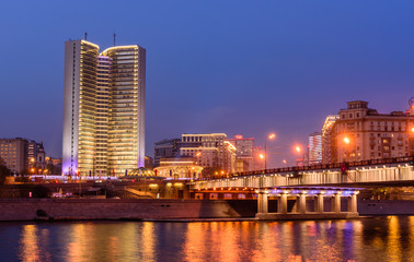 Cityscape of Moscow at night. House-book at Novy Arbat street and embankment of the Moscow river