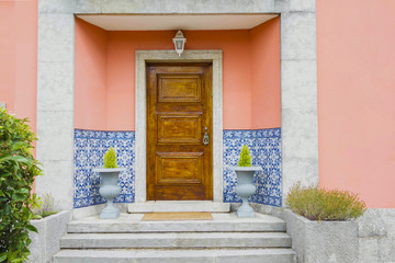 Wooden door - entrance with ceramics and plants