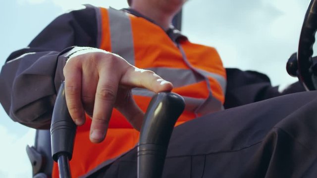 Close up slow motion shot, young man hand drive, operate forklift