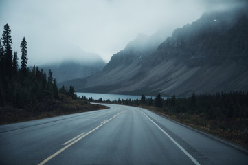 Mysterious road trip with rocky mountains in misty on gloomy at Banff national park © Mumemories