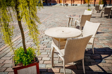 Empty summer terace tables in old town of city. Open air Cafe