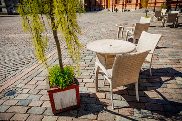 Empty summer terace tables in old town of city. Open air Cafe