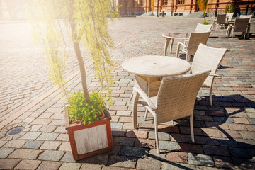 Empty summer terace tables in old town of city. Open air Cafe