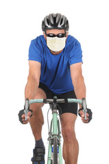 Fototapeta na wymiar Closeup of a man wearing a covid-19 surgical mask riding a road bike isolated on white.