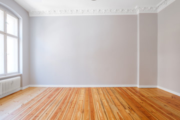 empty apartment room with wooden floor and stucco ceiling