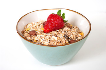 Granola with strawberry in ceramic bowl. Healthy eating for breakfast. close up.