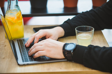 mans hands on laptop keyboard freelance concept
