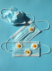 
medical mask with flowers on a blue background