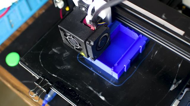 The 3D printer printed blue plastic model. modern technology