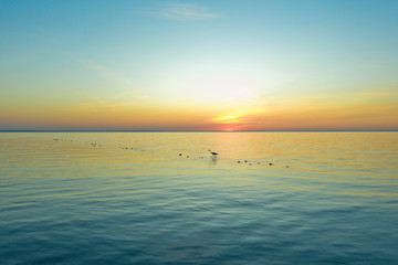 Fototapeta premium Chapel fishing at sunset in a mysterious silhouette. spectacular and very colorful sunset - Aerial Flight