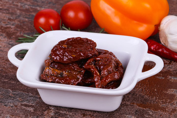 Dried tomatoes in the bowl with olive oil