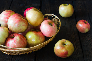 Fototapeta na wymiar Apples in a basket and honey on a black background.