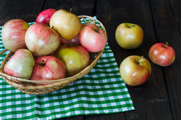 Apples in a basket and honey on a black background.