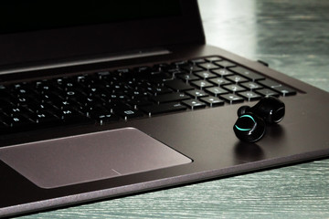 bluetooth ear phone resting on the notebook