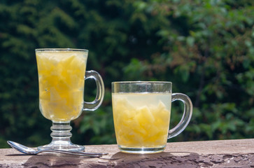 pineapple jelly in glass mugs on a wooden table in the garden