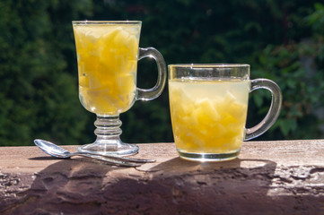 pineapple jelly in glass mugs on a wooden table in the garden