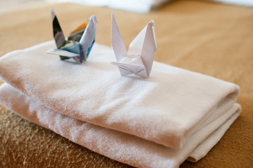 Room service in a hotel in Asia. Origami paper figures
