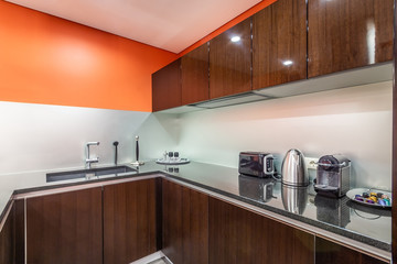 Fragment of a new stylish kitchen with modern kitchen appliances and a granite worktop