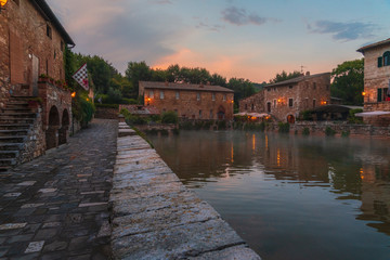 Central square with the thermal pool in old town Bagno Vignoni in the evening. Tuscany, Italy