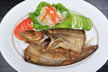 Fried garlic soft fish. Fried river fish with garlic and pepper background