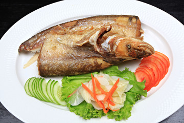 Fried garlic soft fish. Fried river fish with garlic and pepper background