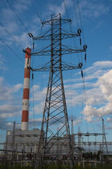 View of a power plant with many power lines on a background of beautiful cloudy sky