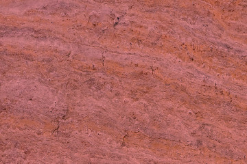 Red marble stone background pattern or texture. Onyx texture of natural stone. Surface of the marble with red tint.