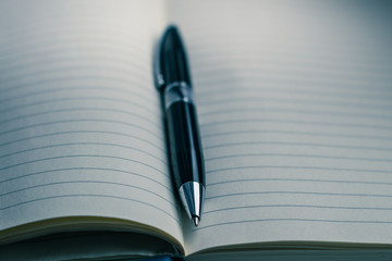 dark pen and notepad on the table