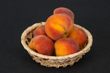 Peach heap in the wooden basket