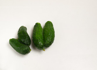 Ugly Siamese-twin cucumbers on a white background. Copy space. Horizontal orientation.