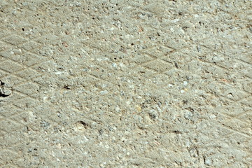 An iron plate with a diamond pattern covered with dried light gray cement. Background for text, design and wallpaper.