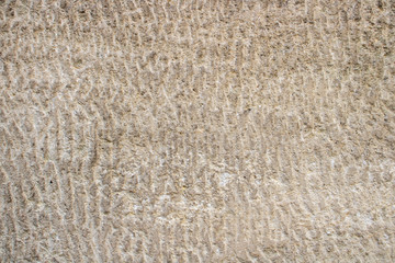 Hand carved old stone as background, pattern or texture