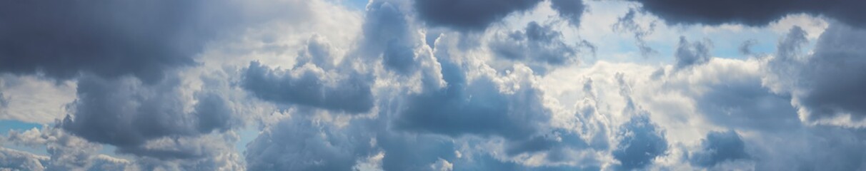 Beautiful cloudy sky with rain storm background. Panoramic sky composition in high resolution. Morning cloudy at daylight with white cumulus clouds.
